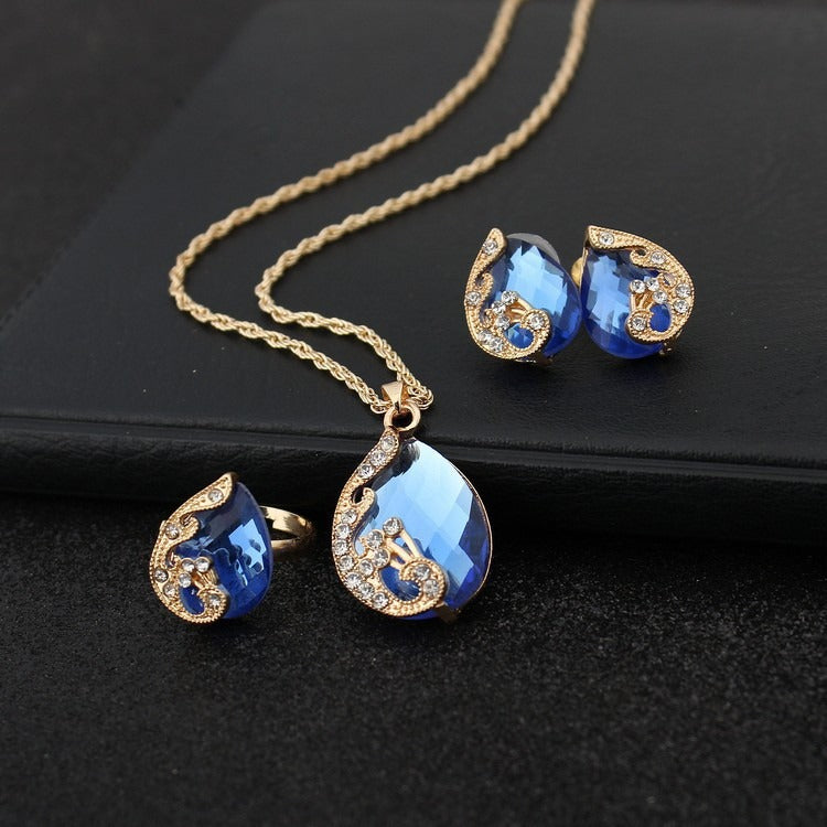 Pia – Schmuckset Halskette und Ohrringe aus blauem und goldenem Kristall